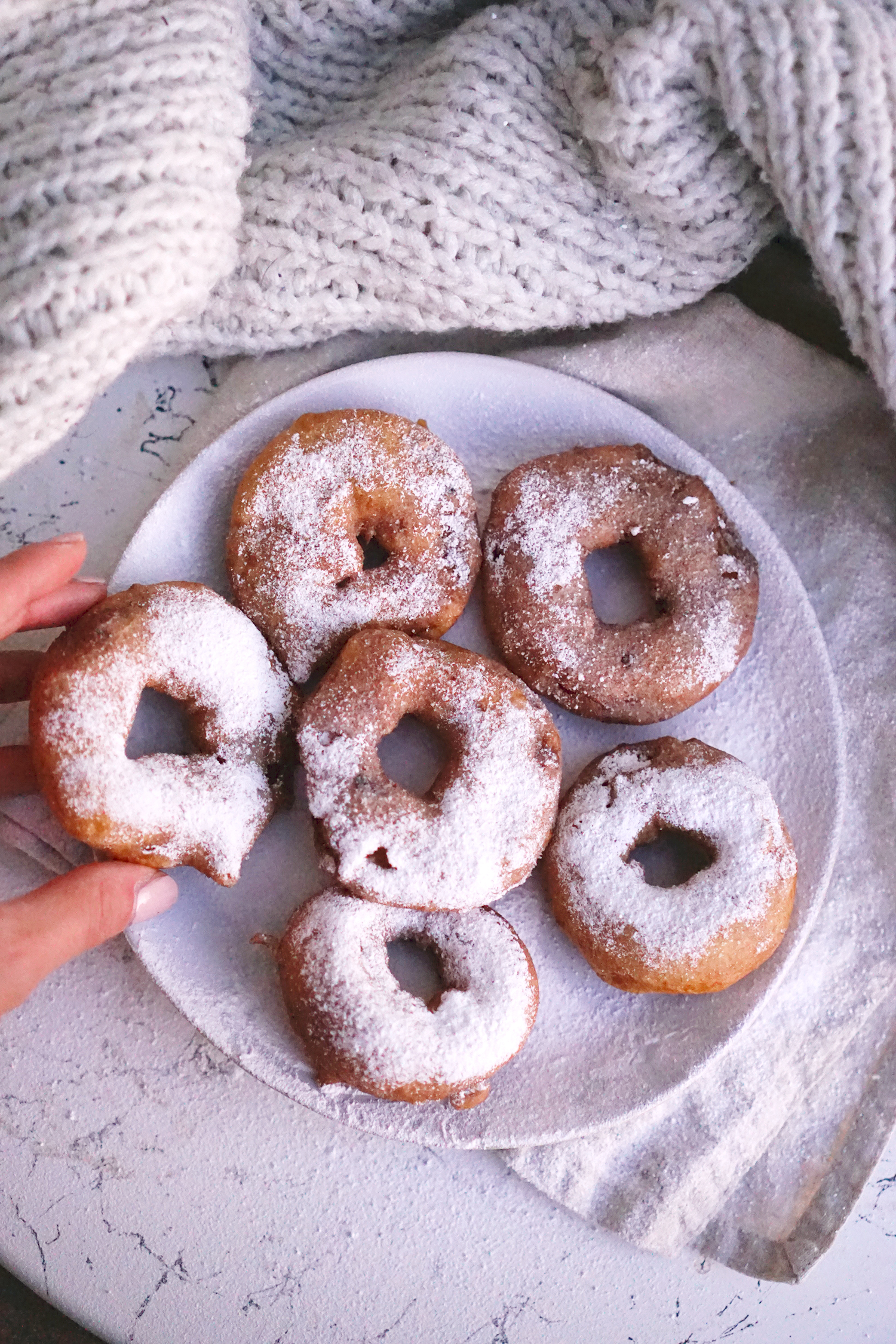 gluten free apple fritter doughnuts covered in icing sugar