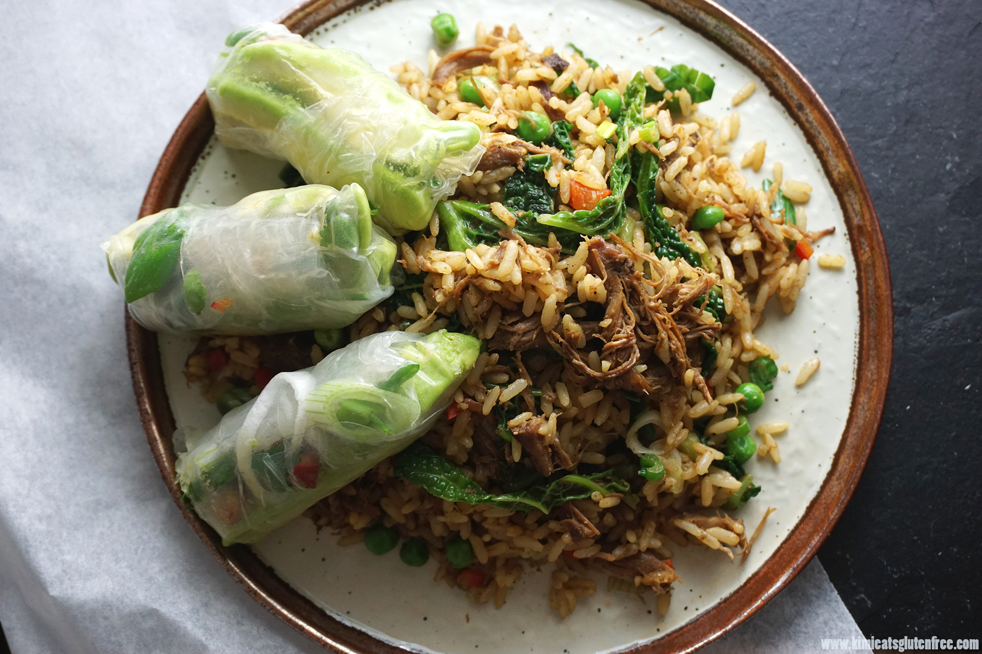 Gluten free Chinese crispy duck fried rice with fresh avocado spring rolls on the side