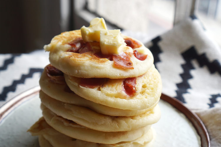 Gluten free American style bacon pancakes with butter melting on top