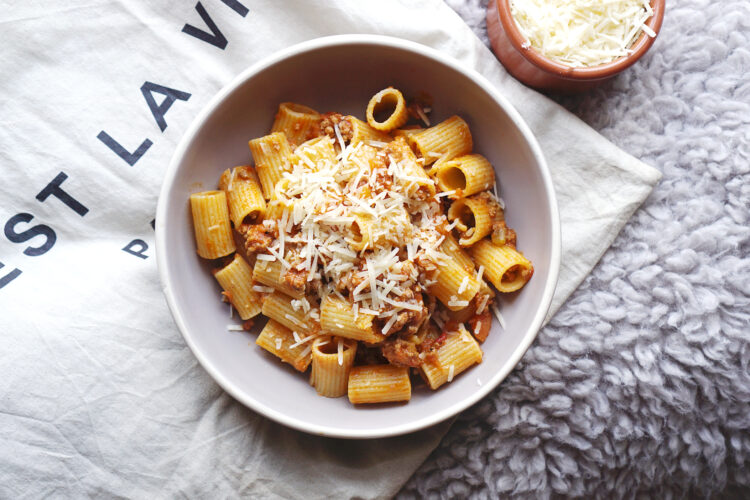 Classic Italian bolognese sauce with gluten free Pasta Rummo rigatoni and grated parmesan cheese