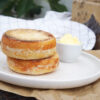 Incredibly soft homemade gluten free English muffins with a toasted cornmeal outer layer, served with butter