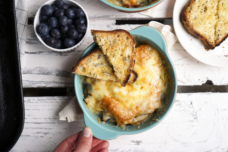 Creamy cheesy baked eggs with roasted mediterranean vegetables, double cream, extra mature cheddar and grana padano + toasted Belle & Wilde gluten free seeded bread with butter